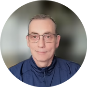 A headshot of Robertson Odom, Principal Software Engineer at CarMax. He has short gray hair and glasses, and is smiling.